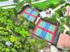 Aerial view of pickleball courts surrounded by lush greenery, providing a recreational amenity at 307 Monterey St, Kissimmee, FL 34759