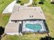 Aerial view of the home featuring a screened pool, shed, and well-maintained landscaping at 3150 Sawgrass Ct, Kissimmee, FL 34746
