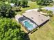 Lush aerial view showcasing a screened pool and a private backyard at 3150 Sawgrass Ct, Kissimmee, FL 34746