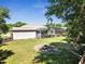 Spacious backyard with screened-in pool, fire pit and a partial view of the home's exterior at 3150 Sawgrass Ct, Kissimmee, FL 34746