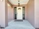 Close-up of the front door with sidelights, and an elegant hanging lantern at 3150 Sawgrass Ct, Kissimmee, FL 34746