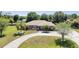 Charming single-story home featuring a circular driveway and lush landscaping at 3150 Sawgrass Ct, Kissimmee, FL 34746