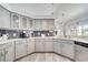 Stylish kitchen showcasing white countertops, gray cabinets, and a dark tile backsplash, creating a modern aesthetic at 3150 Sawgrass Ct, Kissimmee, FL 34746
