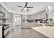 A bright, modern kitchen featuring stainless steel appliances and white countertops, complemented by gray cabinetry at 3150 Sawgrass Ct, Kissimmee, FL 34746