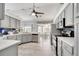 Bright and modern kitchen with gray cabinets, stainless steel appliances, and an adjacent dining area at 3150 Sawgrass Ct, Kissimmee, FL 34746