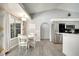 A modern kitchen featuring stainless steel appliances, adjacent to a cozy breakfast nook with bright natural light at 3150 Sawgrass Ct, Kissimmee, FL 34746