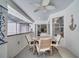 Cozy screened patio with dining set and ceiling fan, perfect for relaxing and entertaining at 3150 Sawgrass Ct, Kissimmee, FL 34746
