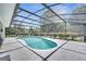 Gorgeous screened pool surrounded by lush landscaping, creating a private backyard oasis at 3150 Sawgrass Ct, Kissimmee, FL 34746