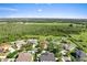 Aerial view of the property nestled in lush surroundings, featuring a greenbelt and various natural elements at 3281 Pawleys N Loop, St Cloud, FL 34769