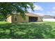 Expansive backyard featuring a well-maintained lawn, screened lanai, and partial shade from mature trees at 3281 Pawleys N Loop, St Cloud, FL 34769