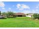 Large, green backyard featuring a well-maintained lawn, and a screened-in lanai at 3281 Pawleys N Loop, St Cloud, FL 34769