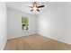 Cozy bedroom with carpet, ceiling fan and window with view of the green outdoors at 3281 Pawleys N Loop, St Cloud, FL 34769