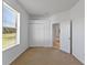 Bright bedroom features a window with blinds and a closet with bi-fold doors at 3281 Pawleys N Loop, St Cloud, FL 34769