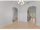 Open dining area with tile flooring and arched doorways leading to the kitchen and other living spaces at 3281 Pawleys N Loop, St Cloud, FL 34769