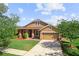 Charming two-story home with a manicured lawn and an attached two-car garage in a suburban neighborhood at 3281 Pawleys N Loop, St Cloud, FL 34769