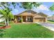 Charming single-Gathering home featuring a well-manicured lawn and attached two car garage at 3281 Pawleys N Loop, St Cloud, FL 34769