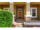 Inviting front porch featuring stone accents, a modern light fixture, and a beautiful wood door at 3281 Pawleys N Loop, St Cloud, FL 34769