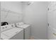 Practical laundry room with side-by-side washer and dryer and wire shelving at 3281 Pawleys N Loop, St Cloud, FL 34769