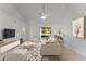 Bright living room featuring neutral tones, a ceiling fan, and sliding door access to outdoor area at 3281 Pawleys N Loop, St Cloud, FL 34769