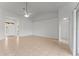 Bright living room featuring neutral tile flooring, ceiling fan, and arched doorway at 3281 Pawleys N Loop, St Cloud, FL 34769