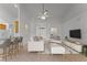 Bright, staged living area with neutral furnishings and an open view into the kitchen area at 3281 Pawleys N Loop, St Cloud, FL 34769