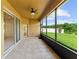 Covered patio with tile floor, fan and sliding glass doors leading to the landscaped yard at 3281 Pawleys N Loop, St Cloud, FL 34769