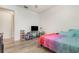 Comfortable bedroom with a large bed, vinyl floors, a ceiling fan, and plenty of natural light at 360 Westchester Dr, Deland, FL 32724