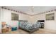 Cozy bedroom featuring wood-look floors, a floral border, and dual windows for ample natural light at 360 Westchester Dr, Deland, FL 32724