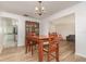 Inviting dining room featuring wood floors, a classic chandelier, and a charming wooden dining set at 360 Westchester Dr, Deland, FL 32724