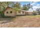 Side view of a single-story home featuring a metal roof and a spacious yard at 360 Westchester Dr, Deland, FL 32724