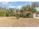 Spacious yard with a single-story home, complimented with lush landscaping and a metal roof at 360 Westchester Dr, Deland, FL 32724