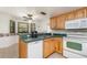 Bright kitchen with green counters, wooden cabinets, and standard appliances offers a functional space at 360 Westchester Dr, Deland, FL 32724