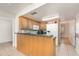 The kitchen features oak cabinets, a breakfast bar with green countertop, and white appliances at 360 Westchester Dr, Deland, FL 32724