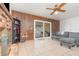 Living room featuring a brick fireplace, tile floors, and sliding glass doors to outside patio at 360 Westchester Dr, Deland, FL 32724
