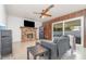 Cozy living room featuring a brick fireplace, tile floors, and sliding glass doors at 360 Westchester Dr, Deland, FL 32724