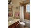 Neutral bathroom with a granite countertop vanity, shower, and patterned decorative mirror at 3609 Azurite Ct, Deland, FL 32724