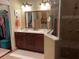 Bathroom with double sinks, a vanity, large mirror, and glass enclosed shower at 3609 Azurite Ct, Deland, FL 32724