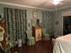 Charming bedroom featuring wood floors and floral-patterned curtains at 3609 Azurite Ct, Deland, FL 32724