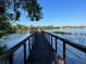 Picturesque community dock extending into a serene lake, providing residents with a peaceful retreat and scenic views at 3609 Azurite Ct, Deland, FL 32724
