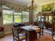 Dining room with wooded views and ornate table with seating for four at 3609 Azurite Ct, Deland, FL 32724