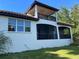 Home's exterior with a balcony, covered patio, and large windows overlooking the backyard at 3609 Azurite Ct, Deland, FL 32724