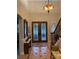 Elegant foyer featuring a decorative chandelier, staircase, and glass paneled double doors at 3609 Azurite Ct, Deland, FL 32724
