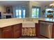 Bright kitchen featuring white countertop, farmhouse sink, and stainless-steel dishwasher at 3609 Azurite Ct, Deland, FL 32724