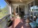Screened lanai with brick floor, ceiling fan, and glass-topped table with chairs at 3609 Azurite Ct, Deland, FL 32724