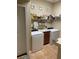 Practical laundry room features a utility sink, washer, dryer, and storage shelves at 3609 Azurite Ct, Deland, FL 32724