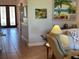 Inviting living room boasts tile flooring, neutral colors, and beach themed artwork at 3609 Azurite Ct, Deland, FL 32724