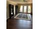 Living room features hardwood floors, neutral walls, and access to a balcony at 3609 Azurite Ct, Deland, FL 32724