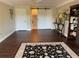 Open living room space with dark floors and a sliding barn door at 3609 Azurite Ct, Deland, FL 32724