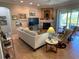 Spacious living room boasts a fireplace, neutral decor, and a walkout to the lanai at 3609 Azurite Ct, Deland, FL 32724