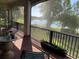 Relaxing screened porch overlooking water features, plants, and rod iron railing at 3609 Azurite Ct, Deland, FL 32724